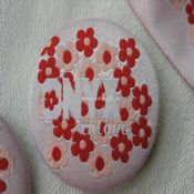 Tin badge wrapped by embroidered fabric