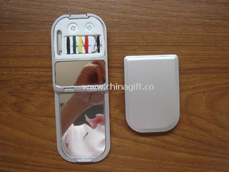 Compact mirror with sewing kit