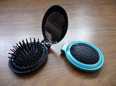 Oval shaped plastic case mirror with comb