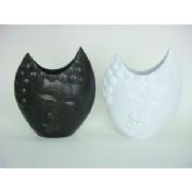 Noir / blanc vase en bois de forme visage images